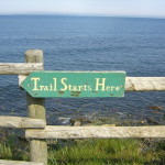 trail starts sign on fence